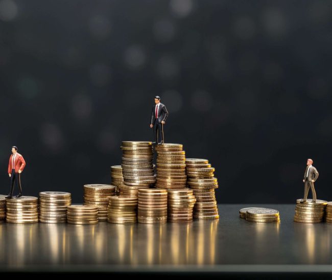 two business men standing in front of stacked coins, in the style of miniature dioramas, metallic textures, thai art, light indigo and dark gray, telephoto lens, photo taken with provia, minimalistic japanese